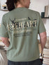 Sage green Fireheart t-shirt with large back print featuring ‘To Whatever End’ quote, antlers, swords, and Aelin Galathynius name from Throne of Glass by Sarah J Maas