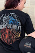 Woman wearing black Fourth Wing T-shirt with Riders Quadrant dragon back print and “I Survived the Threshing” crest detail.