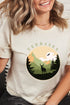Cream Terrasen t-shirt with circular National Park-style graphic showing a stag in a pine forest with mountains, inspired by Throne of Glass by Sarah J Maas