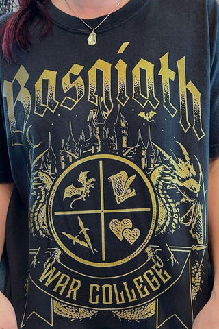 Woman wearing a black T-shirt featuring a Basgiath War College crest with fantasy symbols, dragons. Officially Licensed Fourth Wing Merch.