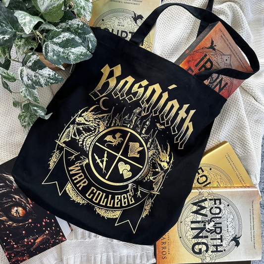 Black Basgiath War College tote bag with gold gothic lettering and War College crest, styled with Fourth Wing and Iron Flame books, Fourth Wing merch inspired by Rebecca Yarros