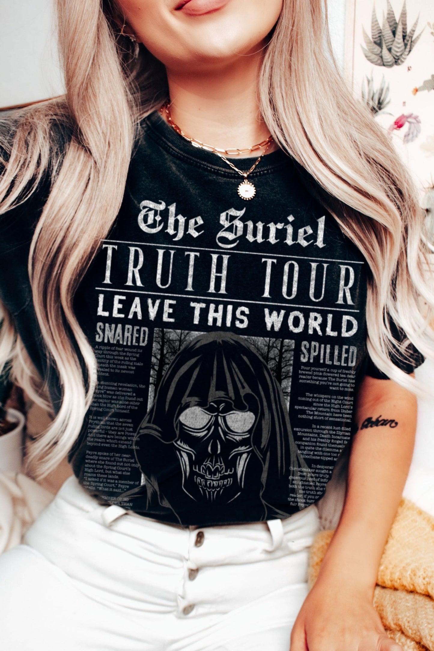 Woman wearing a black “The Suriel Truth Tour” t-shirt with white print, inspired by A Court of Thorns and Roses by Sarah J. Maas, styled like a vintage band tee.