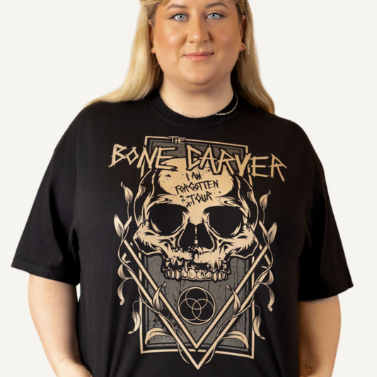 Bone Carver T-Shirt in black on a model — 'I Am Forgotten Tour' skull print, front view. ACOTAR merch.