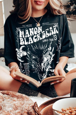 Oversized black Manon Blackbeak t-shirt with white graphic featuring a snarling wyvern, tour-style text, and names of the Thirteen from Throne of Glass.by Sarah J Maas
