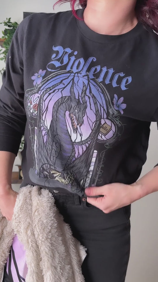 Try-on video: the black Violence sweatshirt, then in close on the print — the stained-glass arch in purple and lilac around the dark winged dragon, with Violence in gothic script above [focal 50 30]