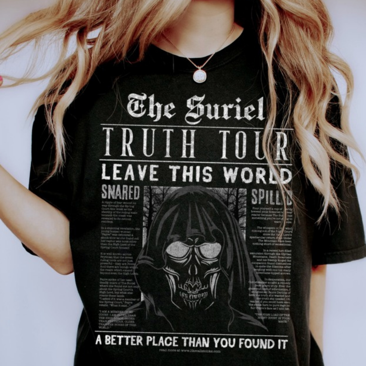 Model in a black The Suriel Truth Tour t-shirt with the hooded skull newspaper print, ACOTAR merch inspired by Sarah J. Maas