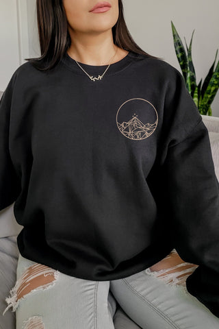 Front view of black sweatshirt featuring Feyre’s Night Court tattoo design from A Court of Thorns and Roses by Sarah J. Maas, printed on the chest.