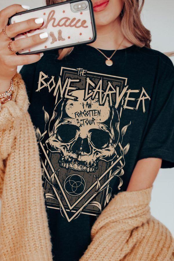 Close-up of black t-shirt featuring a graphic “I Am Forgotten Tour” skull design inspired by the Bone Carver from A Court of Thorns and Roses by Sarah J. Maas