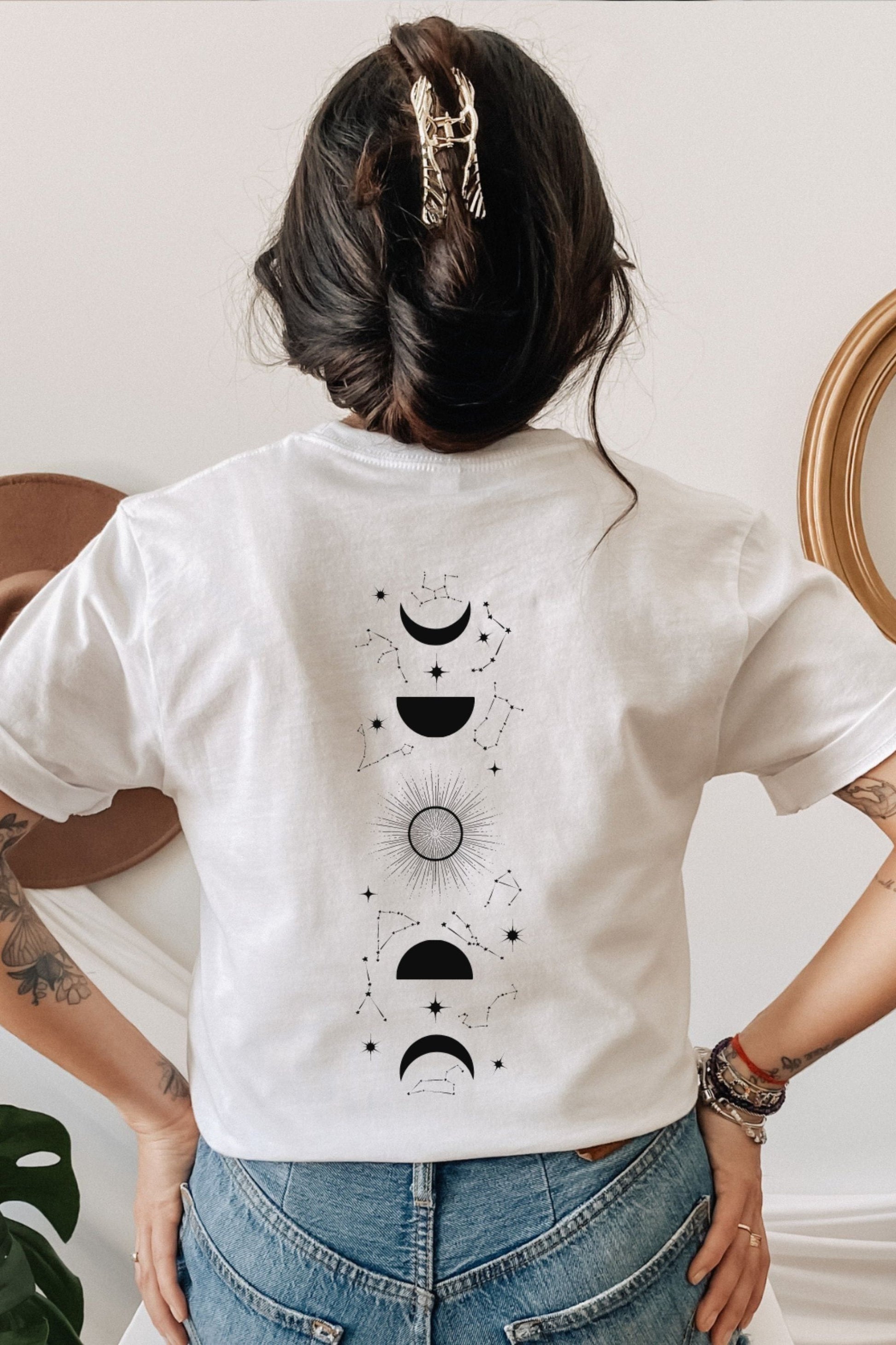 Back view of white t-shirt featuring Feyre’s tattoo design from A Court of Thorns and Roses by Sarah J. Maas, with crescent moon and symbolic markings.