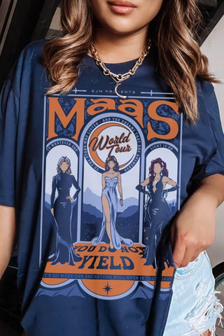 Model wearing a maroon t-shirt from the Maasverse collection, featuring a vintage-style “Maas World Tour” design with Bryce Quinlan (Crescent City), Feyre Archeron (ACOTAR), and Aelin Galathynius (Throne of Glass)—from the books by Sarah J. Maas