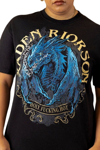 Women wearing Black Fourth Wing shirt featuring blue dragon design and “Xaden Riorson” lettering, with quote “Holy. Fucking. Hot