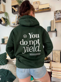 Dark green hoodie with large back print reading ‘You do not yield’ in white serif font, inspired by Aelin from Throne of Glass by Sarah J Maas